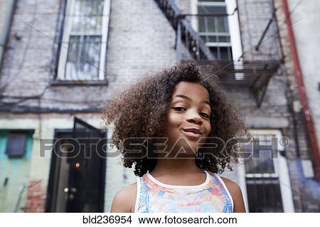 Picture - Portrait of smirking Mixed Race girl. Fotosearch