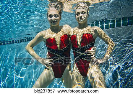 Portrait of synchronized swimmers smiling underwater View Large Photo Image Stock Photo - Portrait of synchronized swimmers smiling underwater. Fotosearch