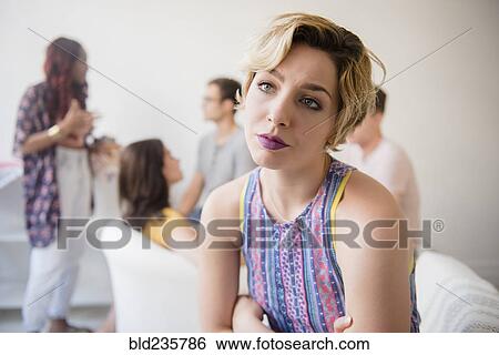 Stock Photograph - Portrait of woman sulking at party. Fotosearch