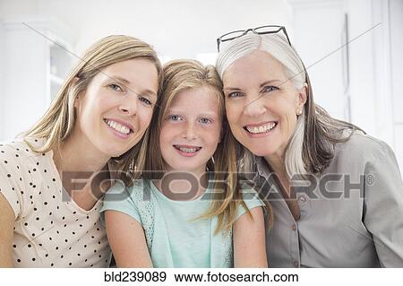 Stock Photo - Portrait of women and girl smiling cheek to cheek. Fotosearch