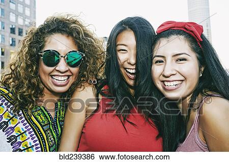 Portrait of women smiling on urban rooftop View Large Photo Image Stock Photograph - Portrait of women smiling on urban rooftop. Fotosearch