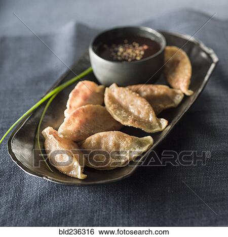 Pot stickers and sauce on tray View Large Photo Image Stock Photograph - Pot stickers and sauce on tray. Fotosearch