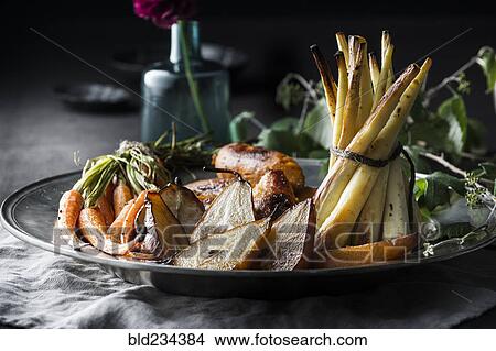 Picture - Potatoes and greens on plate. Fotosearch