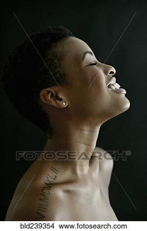 Picture - Profile of Black woman laughing with eyes closed. Fotosearch