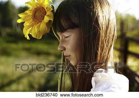 Profile of Caucasian girl with freckles holding sunflower View Large Photo Image Stock Image - Profile of Caucasian girl with freckles holding sunflower. Fotosearch