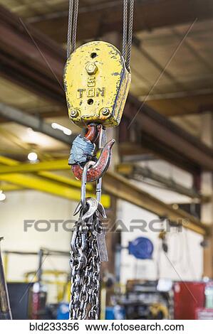 Pulley and chain hanging in factory View Large Photo Image Stock Photograph - Pulley and chain hanging in factory. Fotosearch