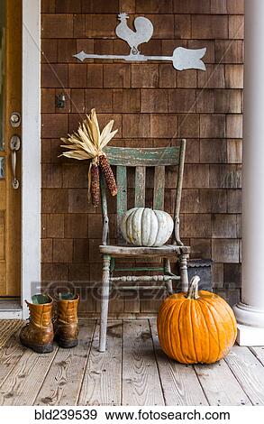 Pumpkins and corn on porch with boots in autumn View Large Photo Image Stock Photo - Pumpkins and corn on porch with boots in autumn. Fotosearch