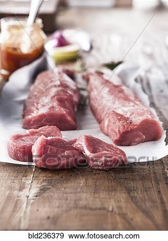 Stock Photo - Raw pork tenderloin on butcher paper. Fotosearch