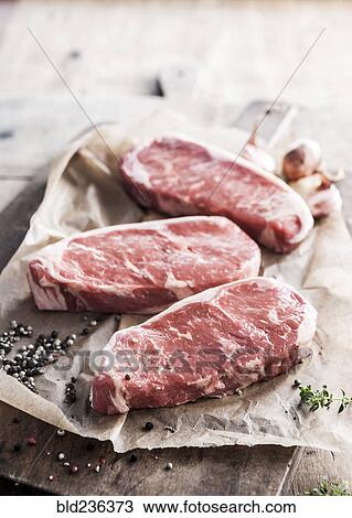 Raw steaks on butcher paper with pepper View Large Photo Image Stock Image - Raw steaks on butcher paper with pepper. Fotosearch