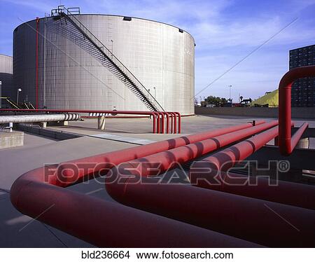 Red pipes near storage tank View Large Photo Image Picture - Red pipes near storage tank. Fotosearch