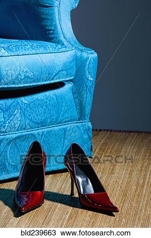 Red shoes on floor near blue armchair View Large Photo Image Stock Image - Red shoes on floor near blue armchair. Fotosearch