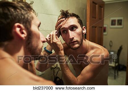 Reflection of Caucasian man plucking eyebrow in mirror View Large Photo Image Stock Image - Reflection of Caucasian man plucking eyebrow in mirror. Fotosearch