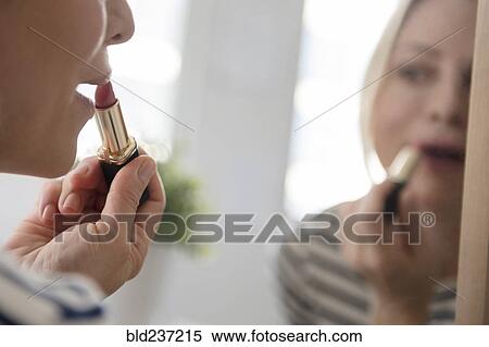 Reflection of Caucasian woman applying lipstick in mirror View Large Photo Image Stock Photography - Reflection of Caucasian woman applying lipstick in mirror. Fotosearch