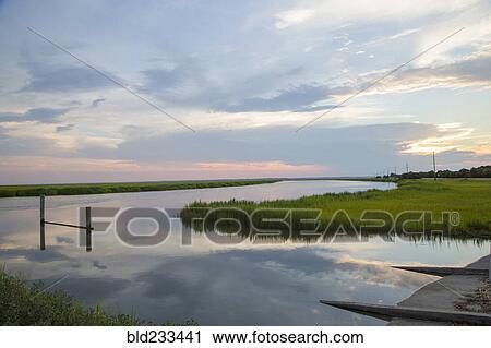 "Reflection of clouds in river, Tybee, Georgia, United States" View Large Photo Image Stock Image - "Reflection of clouds in river, Tybee, Georgia, United States". Fotosearch