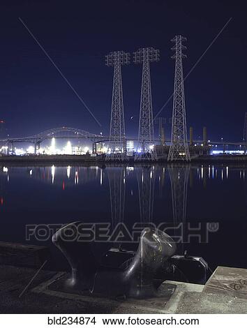 Reflection of metal towers in harbor at night View Large Photo Image Picture - Reflection of metal towers in harbor at night. Fotosearch