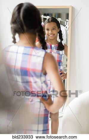 Reflection of Mixed Race girl in mirror View Large Photo Image Stock Image - Reflection of Mixed Race girl in mirror. Fotosearch