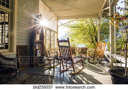 Reflection of sun on porch with rocking chairs View Large Photo Image Stock Photo - Reflection of sun on porch with rocking chairs. Fotosearch