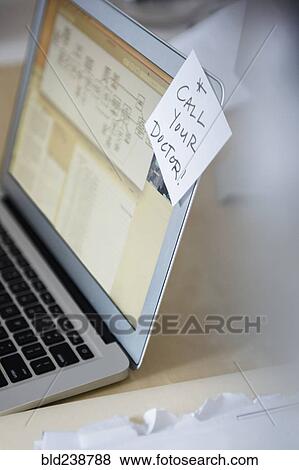 Reminder on adhesive note attached to laptop View Large Photo Image Stock Photo - Reminder on adhesive note attached to laptop. Fotosearch