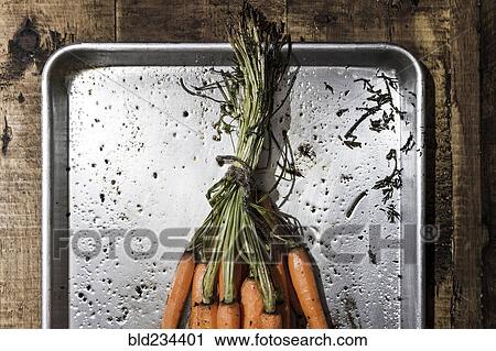 Stock Image - Roasted carrots in pan. Fotosearch