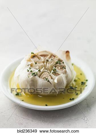 Roasted garlic in olive oil View Large Photo Image Stock Photo - Roasted garlic in olive oil. Fotosearch