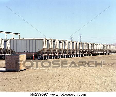 Stock Photo - Row of cargo containers on semi-trucks. Fotosearch