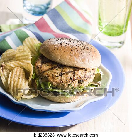 Salmon burger with potato chips View Large Photo Image Stock Image - Salmon burger with potato chips. Fotosearch