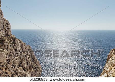 Scenic view of ocean near rock formation View Large Photo Image Stock Image - Scenic view of ocean near rock formation. Fotosearch