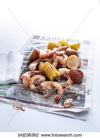 Stock Image - Seafood boil on newspaper. Fotosearch