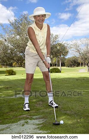 Stock Photograph - Senior Caucasian woman playing golf. Fotosearch