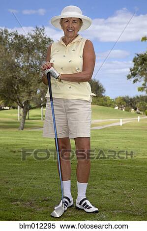 Stock Photography - Senior Caucasian woman playing golf. Fotosearch