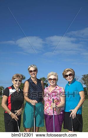 Stock Image - Senior Caucasian women playing golf. Fotosearch