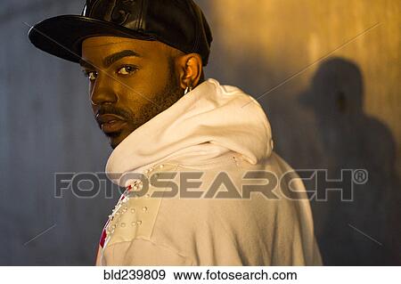 Stock Photo - Serious Black man looking over shoulder. Fotosearch