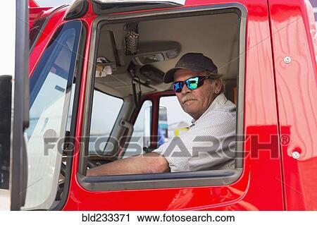 Serious Caucasian semi-truck driver wearing sunglasses View Large Photo Image Stock Image - Serious Caucasian semi-truck driver wearing sunglasses. Fotosearch