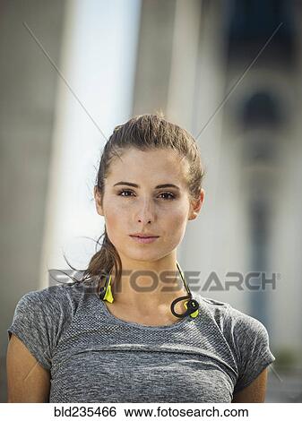Stock Photograph - Serious Caucasian woman posing under overpass. Fotosearch