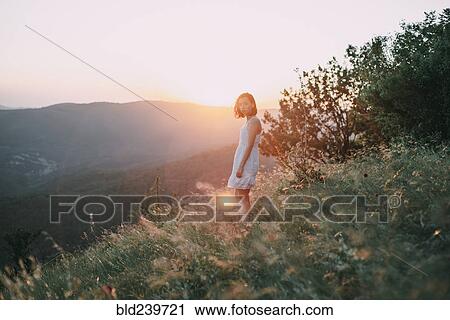 Serious Caucasian woman standing on mountain View Large Photo Image Stock Image - Serious Caucasian woman standing on mountain. Fotosearch