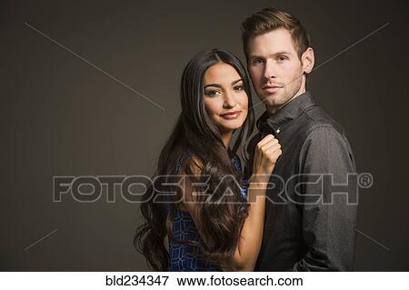 Serious couple hugging View Large Photo Image Stock Photo - Serious couple hugging. Fotosearch
