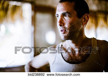 Stock Image - Serious man wearing tank-top. Fotosearch