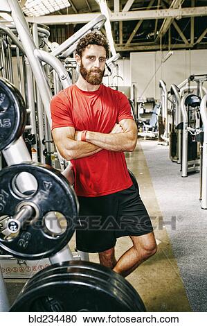 Stock Image - Serious Mixed Race man posing in gymnasium. Fotosearch