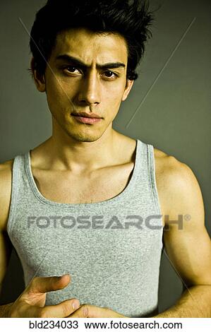 Stock Image - Serious Mixed Race man wearing tank-top. Fotosearch