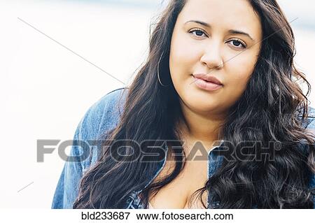 Serious Mixed Race woman near ocean View Large Photo Image Stock Photo - Serious Mixed Race woman near ocean. Fotosearch