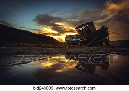 Shipwreck on beach at sunset View Large Photo Image Stock Image - Shipwreck on beach at sunset. Fotosearch