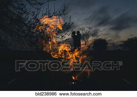 Silhouette of Caucasian couple kissing near fire View Large Photo Image Stock Photograph - Silhouette of Caucasian couple kissing near fire. Fotosearch