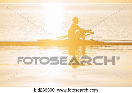 Silhouette of Caucasian man rowing on lake View Large Photo Image Stock Image - Silhouette of Caucasian man rowing on lake. Fotosearch