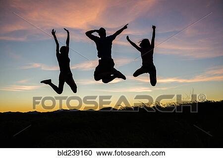 Silhouette of friends jumping for joy at sunset View Large Photo Image Stock Image - Silhouette of friends jumping for joy at sunset. Fotosearch
