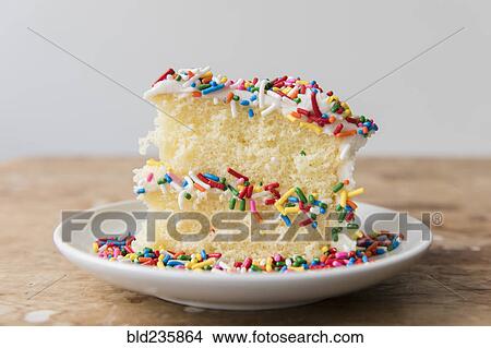 Slice of cake with sprinkles on plate View Large Photo Image Picture - Slice of cake with sprinkles on plate. Fotosearch