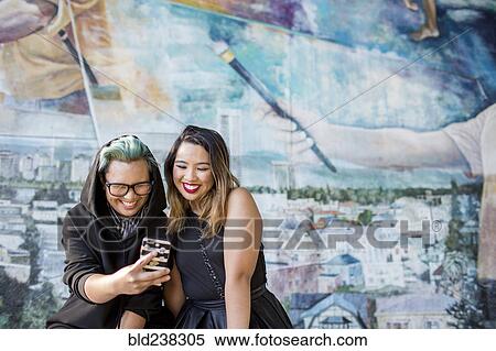 Smiling Asian women posing for cell phone selfie View Large Photo Image Stock Photography - Smiling Asian women posing for cell phone selfie. Fotosearch