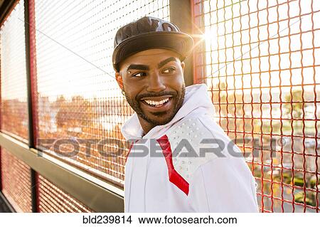 Smiling Black man near fence View Large Photo Image Picture - Smiling Black man near fence. Fotosearch