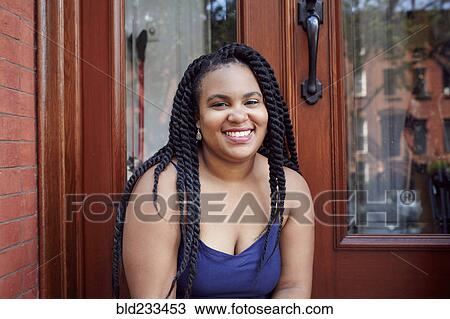 Smiling Black woman in doorway View Large Photo Image Stock Image - Smiling Black woman in doorway. Fotosearch