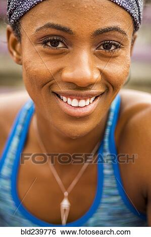 Stock Photograph - Smiling Black woman sweating. Fotosearch