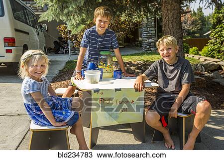 Smiling Caucasian boys and girl selling lemonade View Large Photo Image Stock Image - Smiling Caucasian boys and girl selling lemonade. Fotosearch